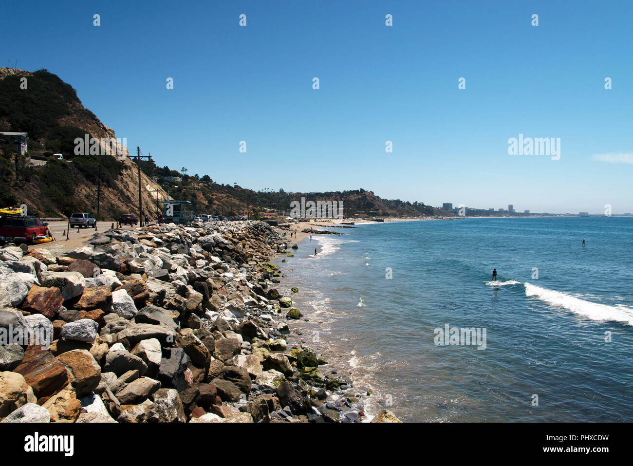 A view of Malibu beach, with stones and rocks and Pacific ocean in summer time in California Stock Photo