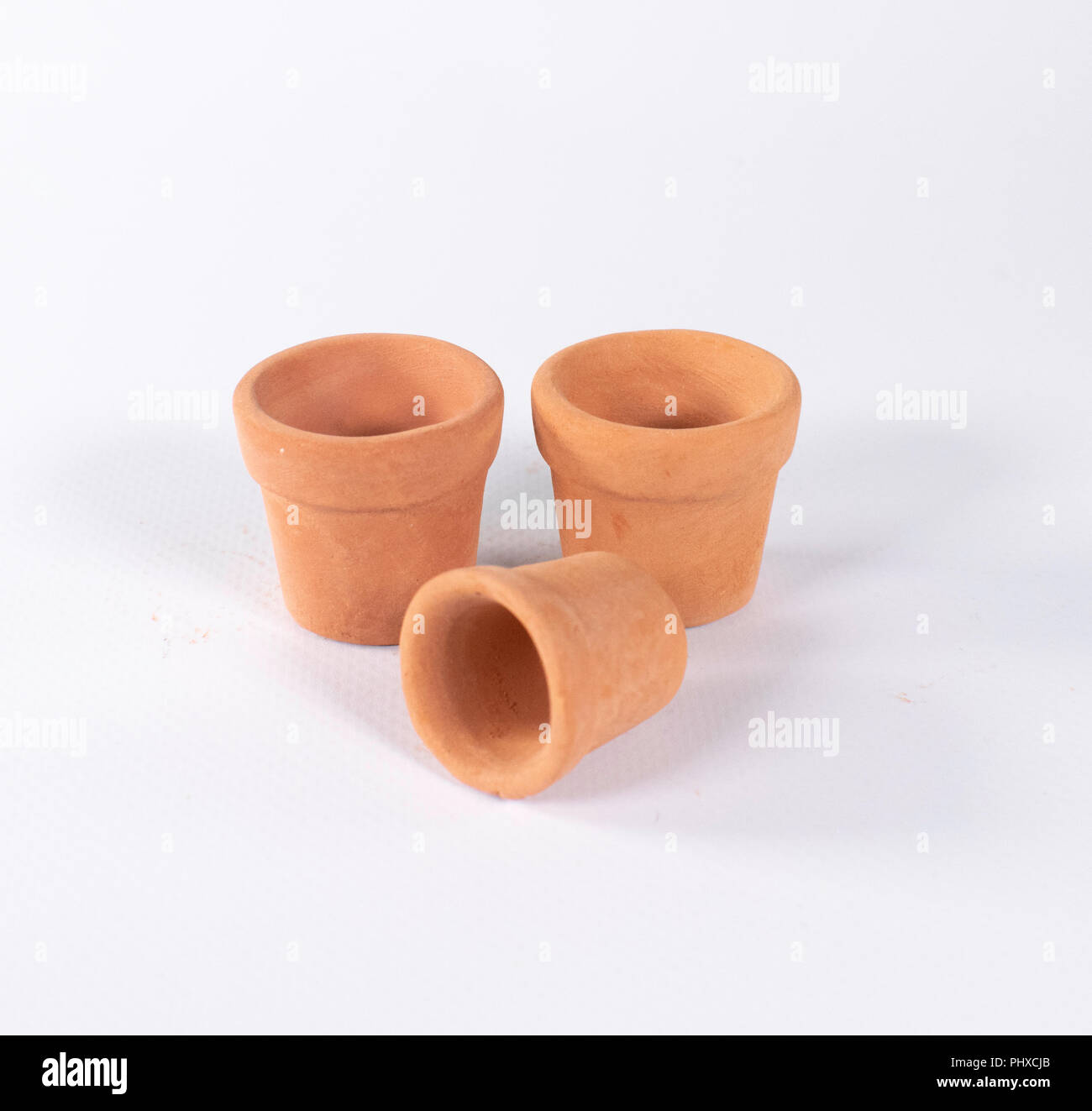 Set of three empty terracotta pots isolated on white Stock Photo - Alamy