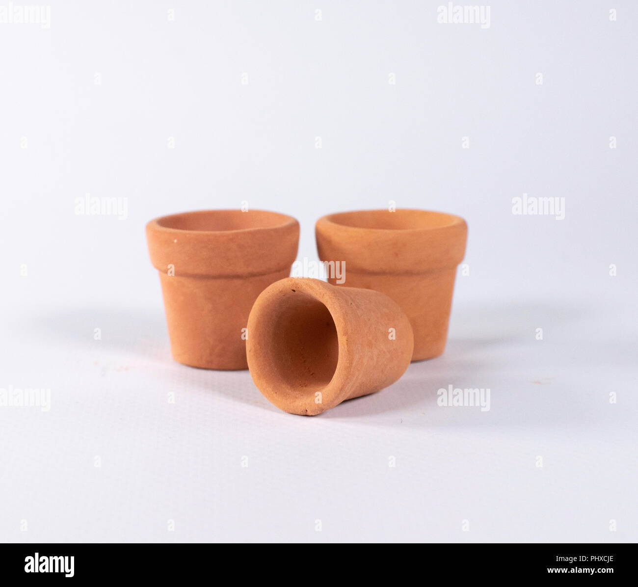 Set of three empty terracotta pots isolated on white Stock Photo - Alamy