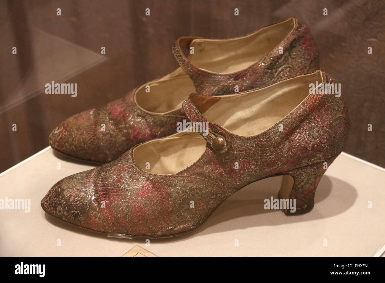 New York City, New York, USA. 2nd Sep, 2018. Mary Jane shoes unidentified maker, ca.1926, made with silk and metallic patterned fabric, embossed metal buttons, seen in the exhibit 'Walk This Way' shoes from the Stuart Weitzman collection held at the New York Historical Society. Credit: Nancy Kaszerman/ZUMA Wire/Alamy Live News Stock Photo