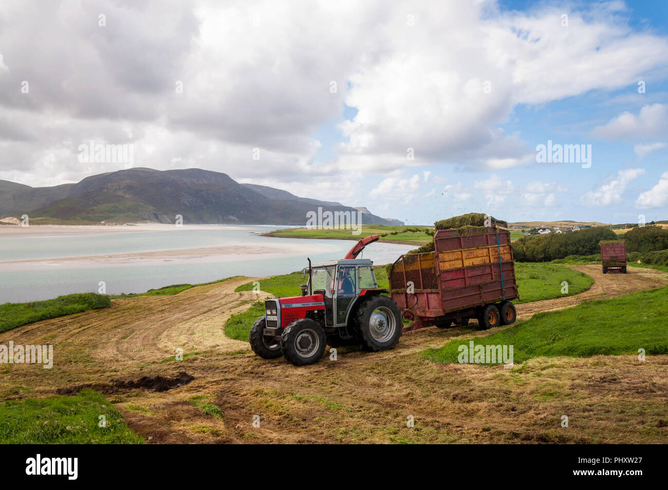Ardara, County Donegal, Ireland weather. 3rd September 2018. Farmers make the most of an overcast but dry day to cut silage grass as winter fodder for their livestock on the north-west coast. Credit: Richard Wayman/Alamy Live News Stock Photo