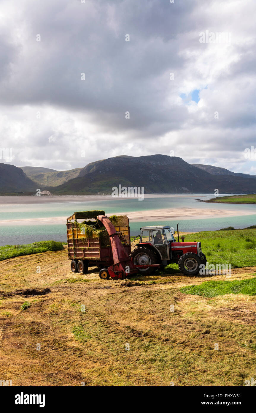 Ardara, County Donegal, Ireland weather. 3rd September 2018. Farmers make the most of an overcast but dry day to cut silage grass as winter fodder for their livestock on the north-west coast. Credit: Richard Wayman/Alamy Live News Stock Photo