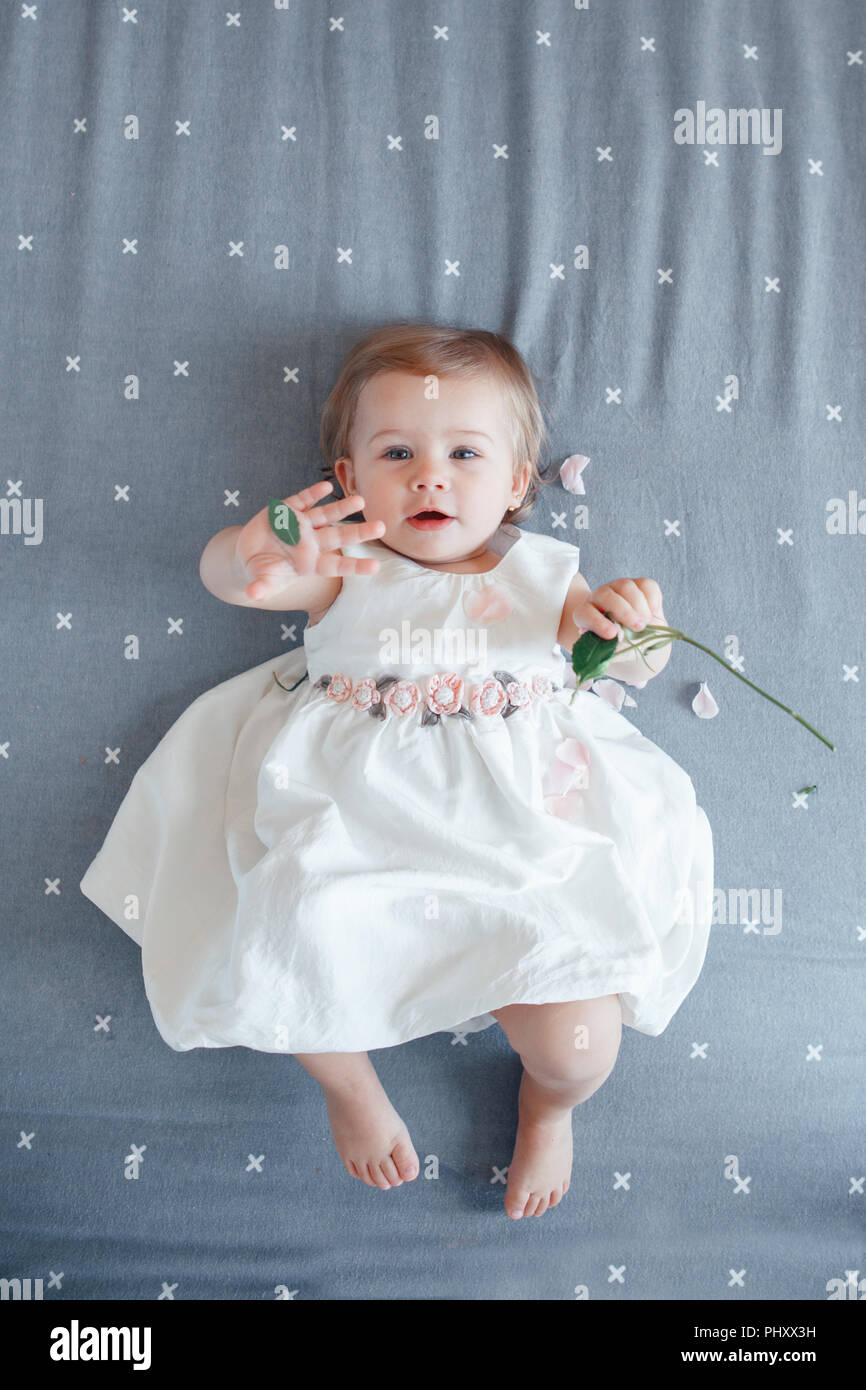 Portrait of cute adorable smiling Caucasian blonde baby girl one