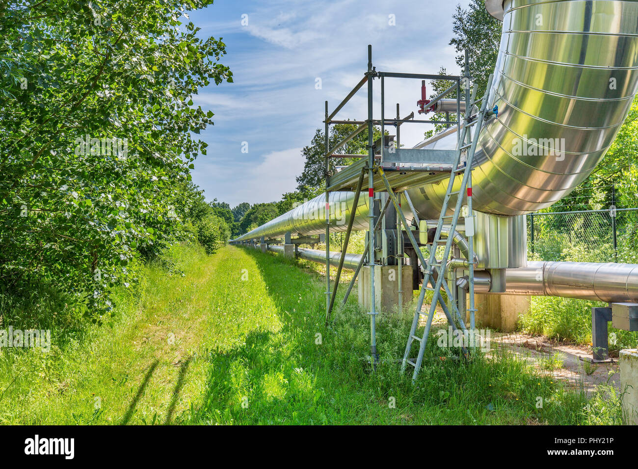 Large metal gas pipeline transports gas in the netherlands Stock Photo