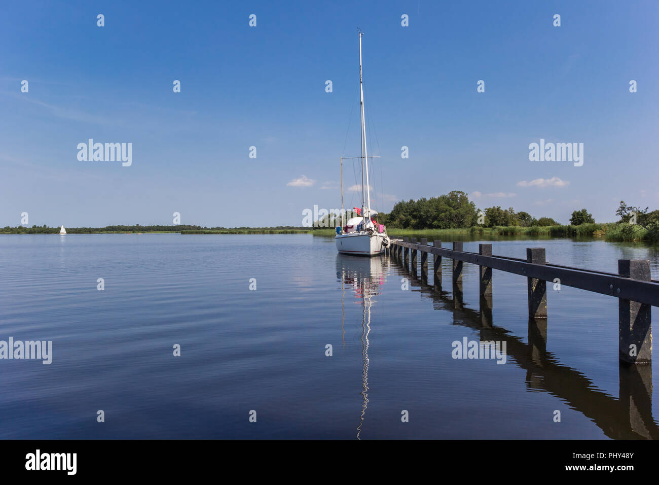 Sailing ship at a jetty in National Park Weerribben-Wieden, Netherlands Stock Photo