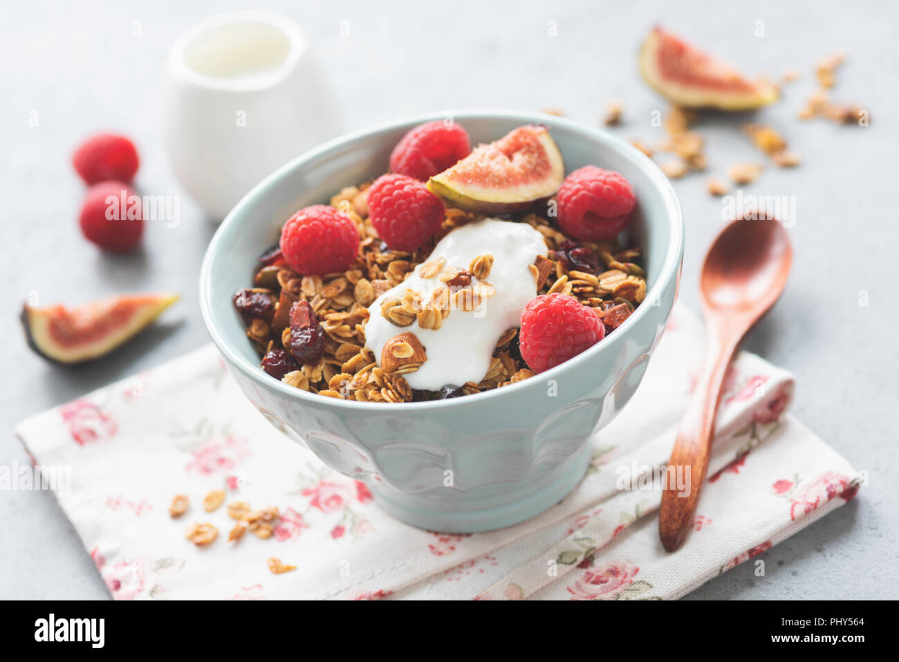 Crunchy granola with greek yogurt and fruits in a bowl. Closeup view, selective focus. Toned image. Healthy eating, healthy lifestyle concept Stock Photo