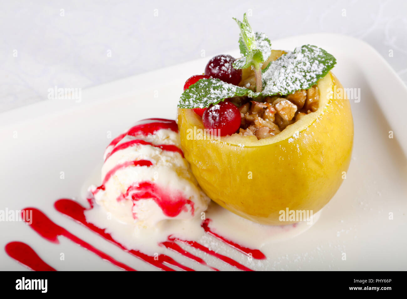 Apple stuffed nuts with ice-cream Stock Photo - Alamy