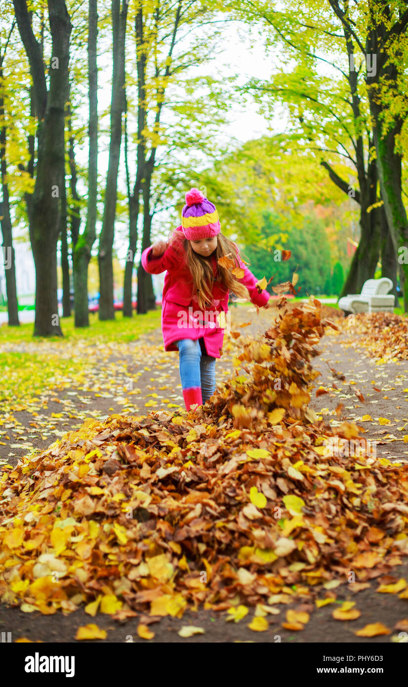 happy little girl spending time outdoor in the autumn park Stock Photo ...
