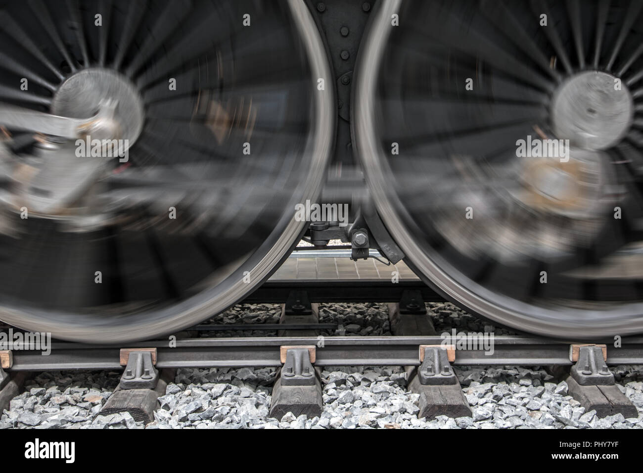 The rotating wheels of steam locomotive on railroad. Detail of steam ...