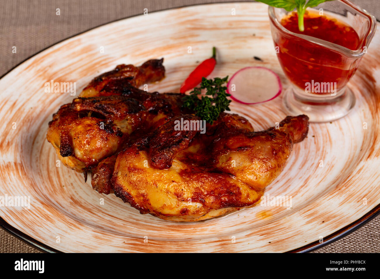 Young roasted chicken with sauce Stock Photo