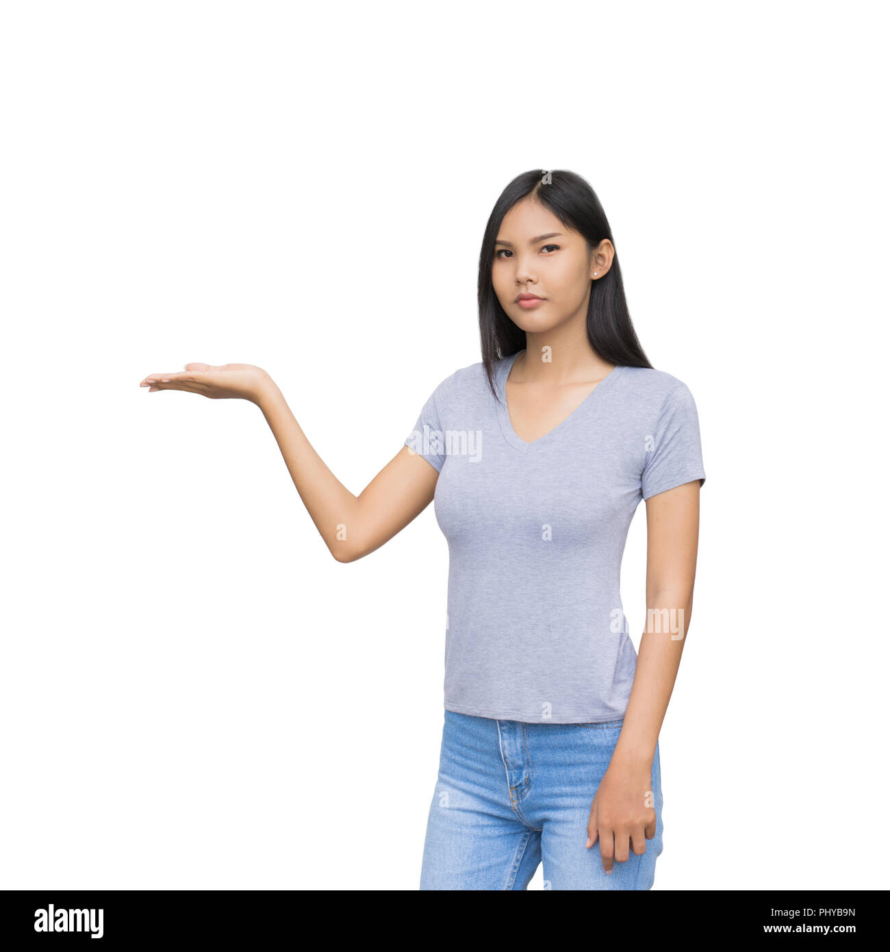 Image of cheerful young lady in plaid shirt standing isolated on white background. Looking camera holding copyspace in hand and pointing. With clippin Stock Photo