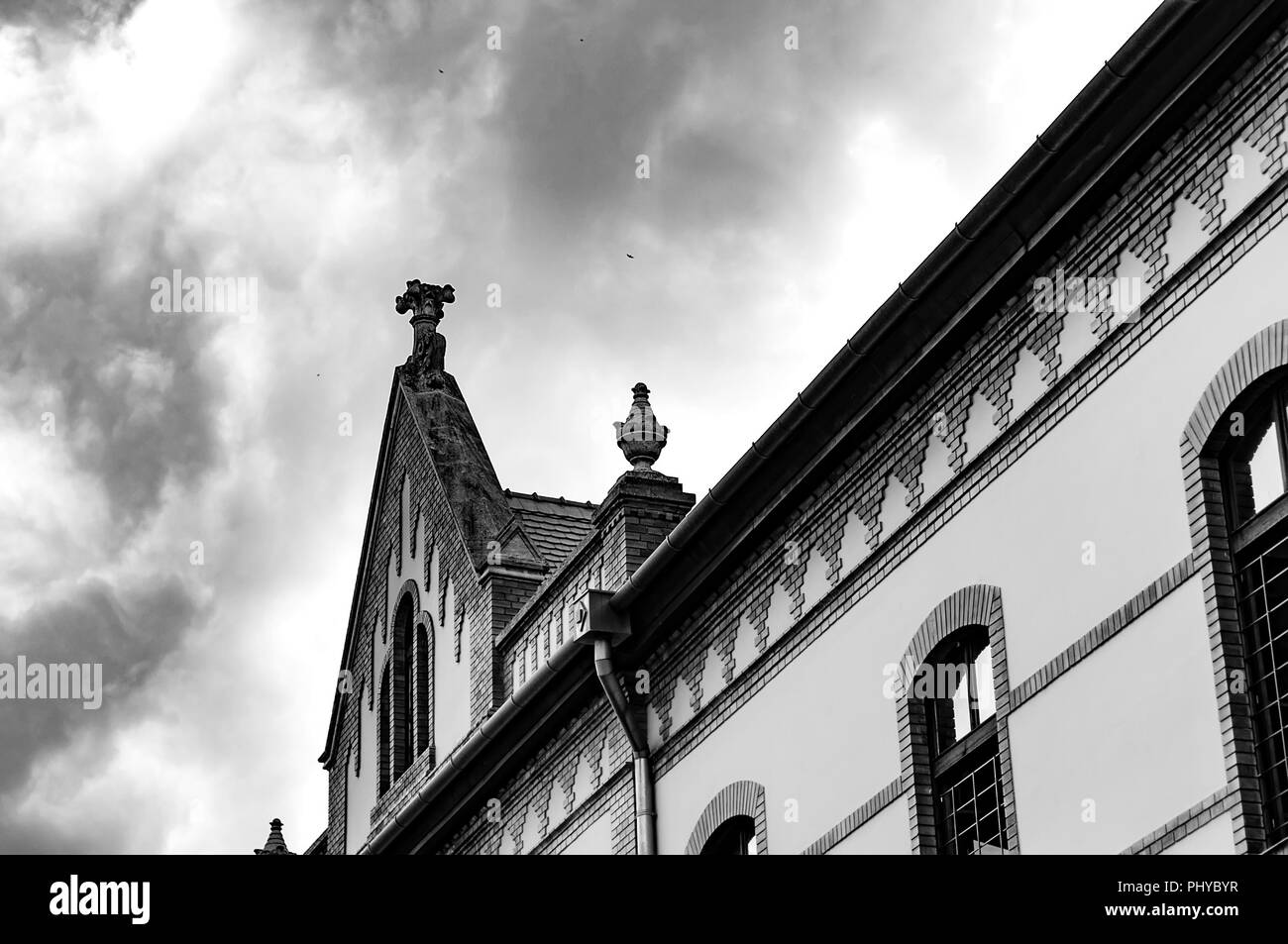 Black and white photo of the historic architecture in Eger, Hungary, Europe on a cloudy, stormy day. Stock Photo