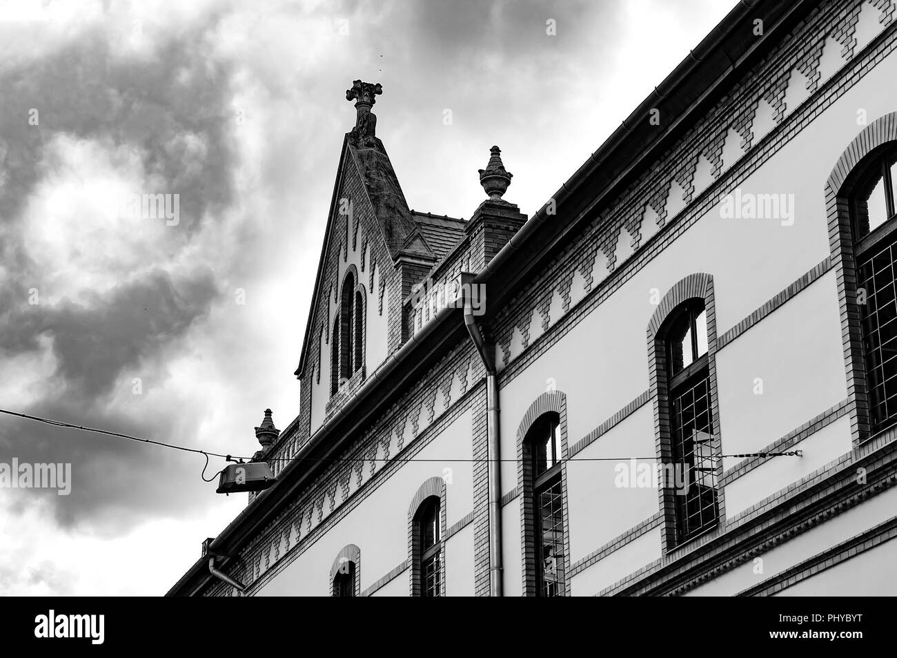 Black and white photo of the historic architecture in Eger, Hungary, Europe on a cloudy, stormy day. Stock Photo