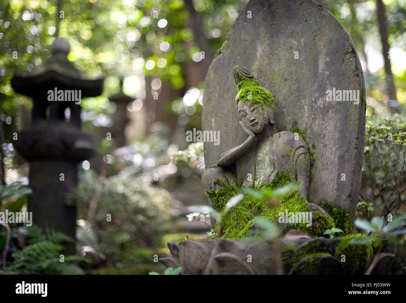 Photo shows a stone Buddha statue on display in the gardens of the Nezu Museum of Art in, Tokyo, Japan on 17 Sept. 2012. The museum was first concep Stock Photo