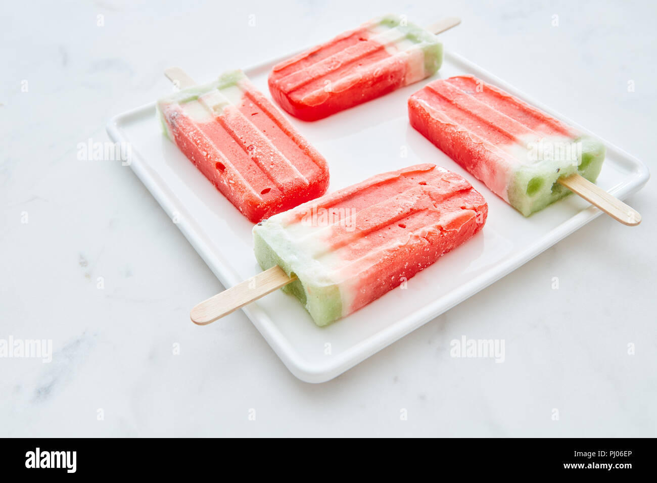Ice lolly. Homemade ice cream in the form of a square in a white plate on a  gray marble background with space for text. Sweet summer dessert Stock  Photo - Alamy