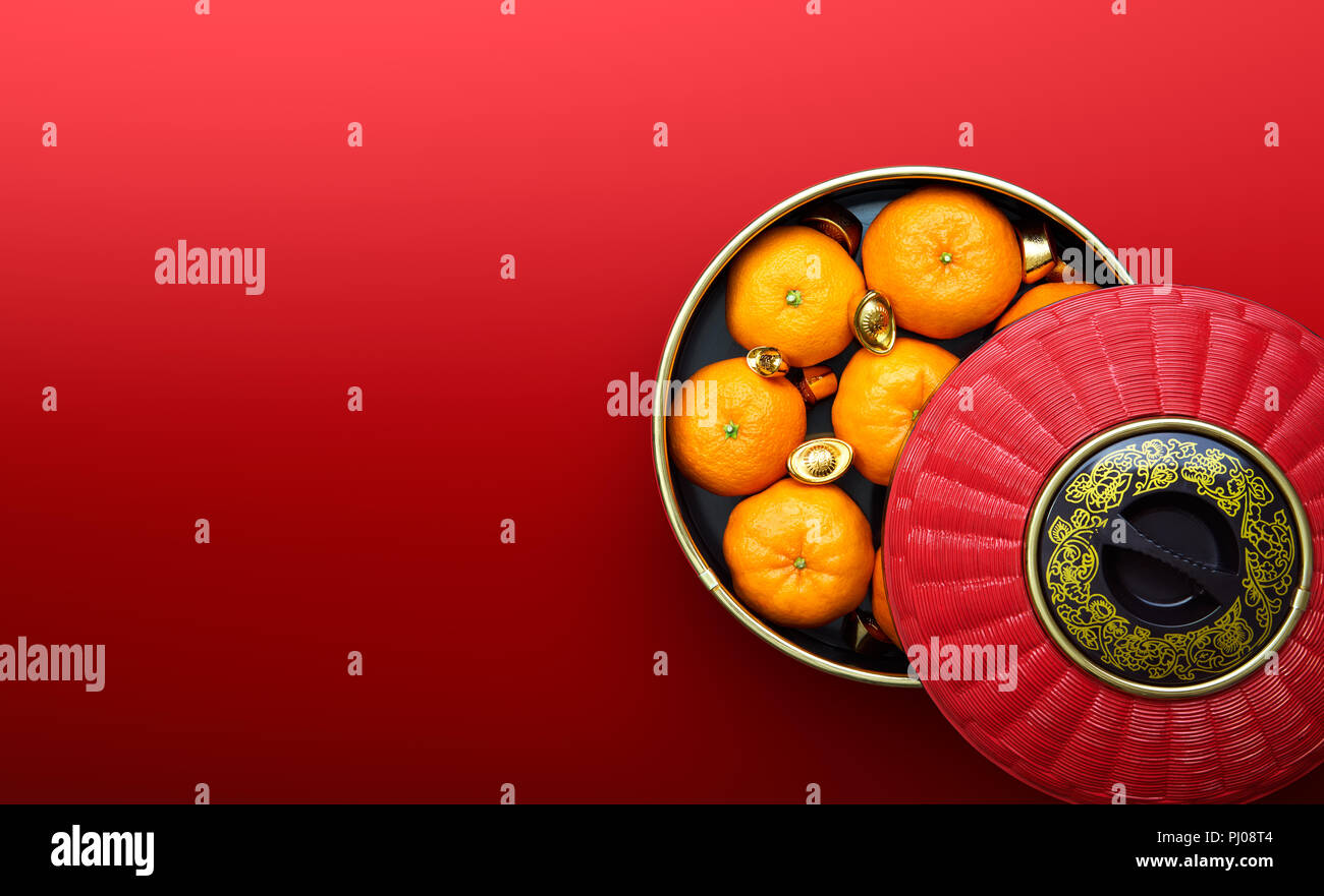 Chinese New Year - Mandarin oranges and chinese gold sycee in traditional container Stock Photo