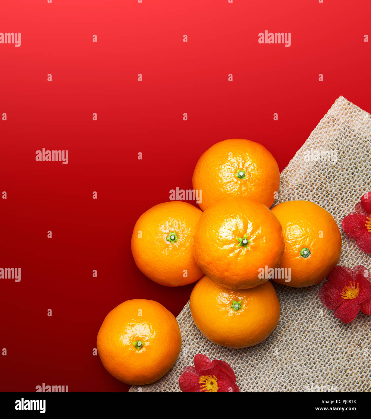 Chinese New Year - Mandarin oranges on red background Stock Photo