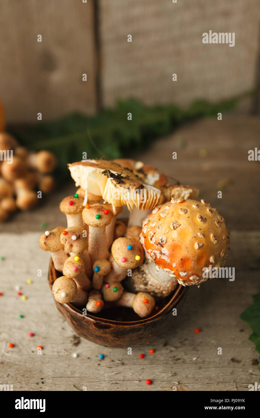 rustic table and cup with mysrerious mushrooms dessert. Woods, fairy tales & mysterious creature concept, magic, fantastic food Stock Photo