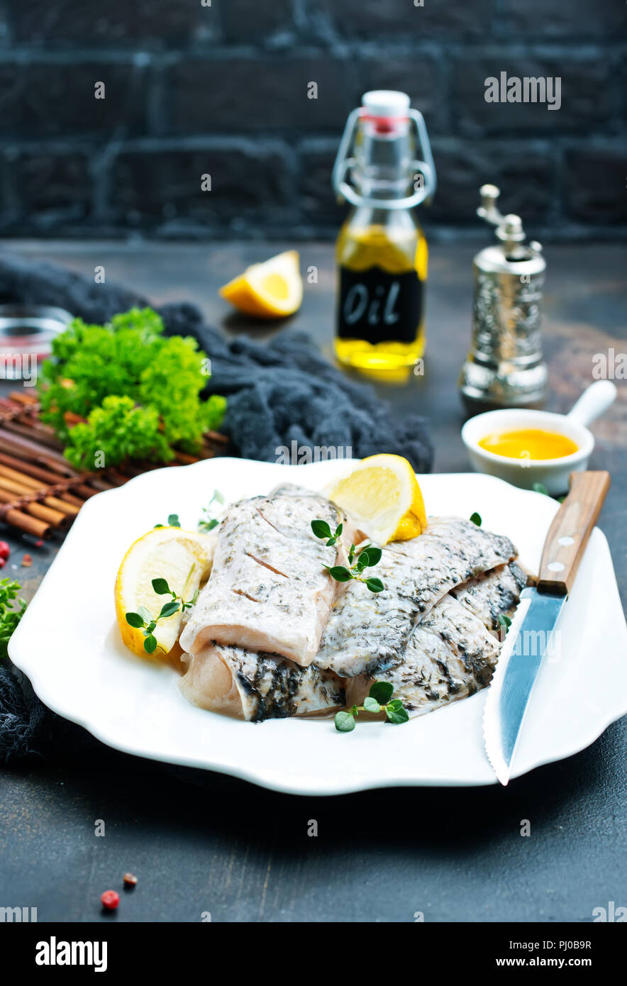 raw fish fillet with spice and lemon Stock Photo - Alamy