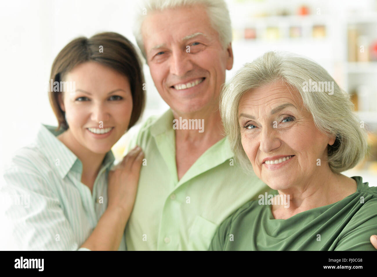 Happy senior parents with daughter at home  Stock Photo