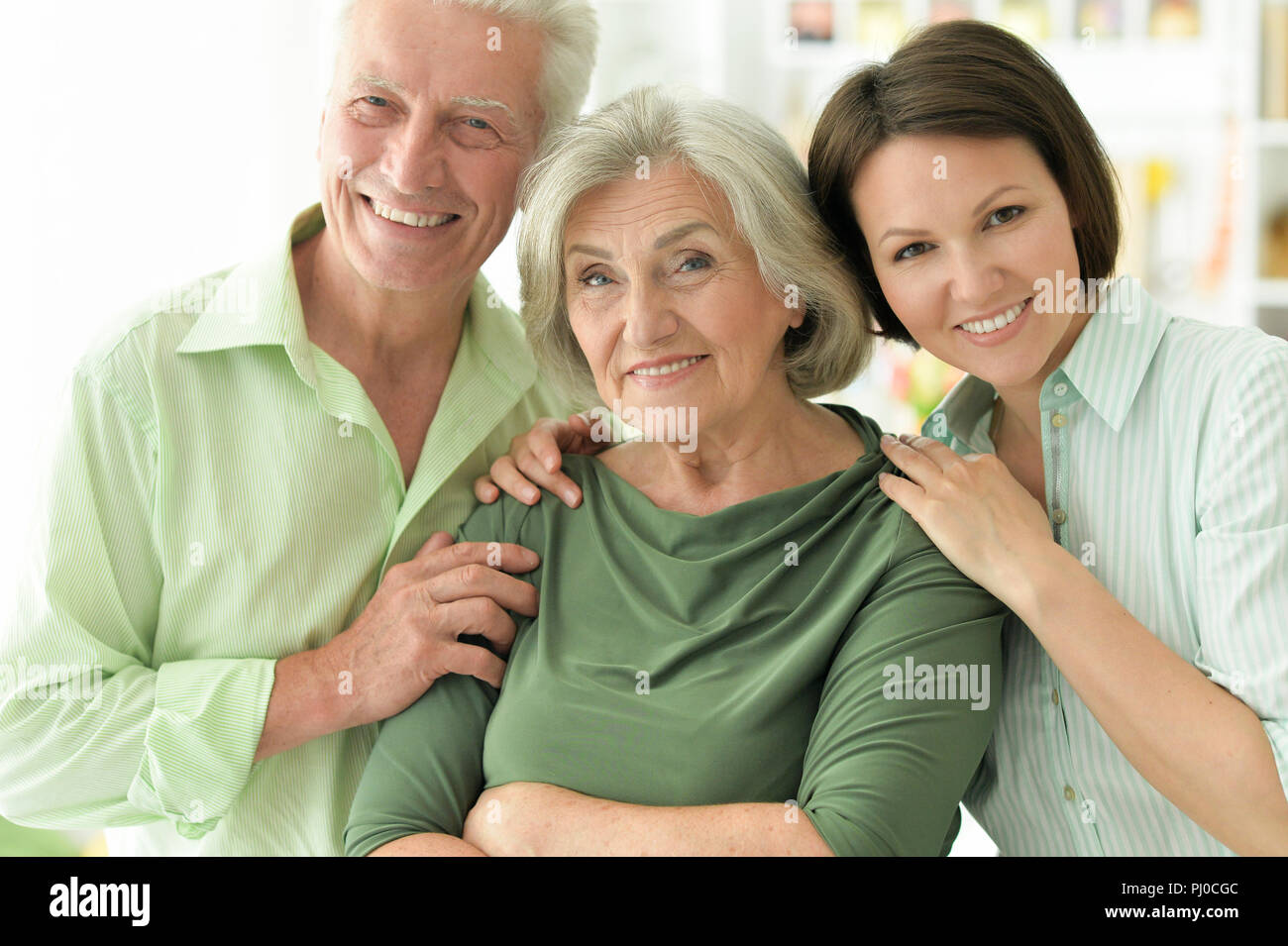 Happy senior parents with daughter at home  Stock Photo