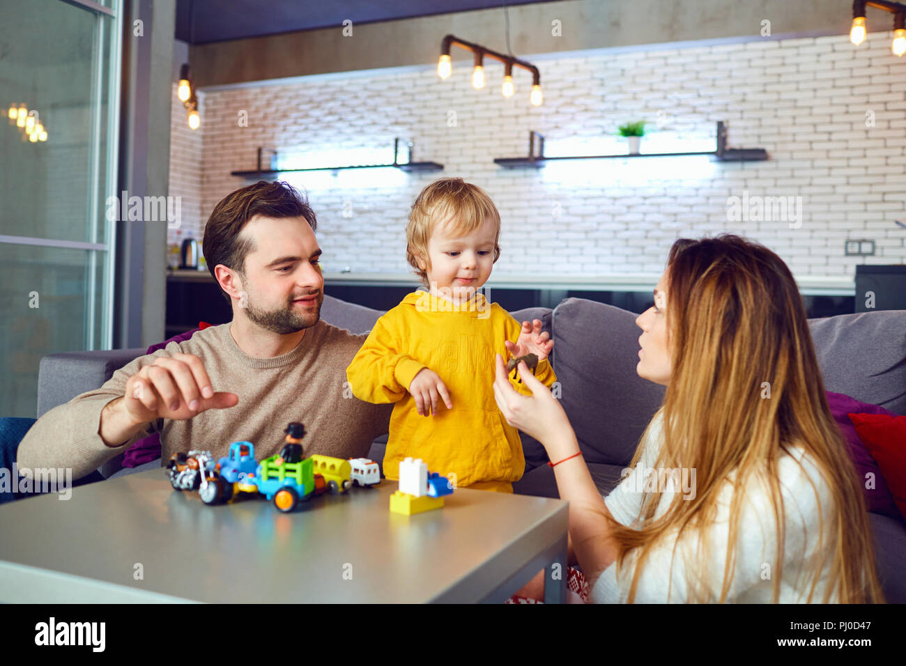 Mother, father and son play  games indoors.  Stock Photo