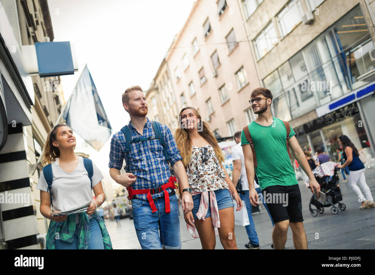 Happy group of tourists traveling and sightseeing Stock Photo - Alamy
