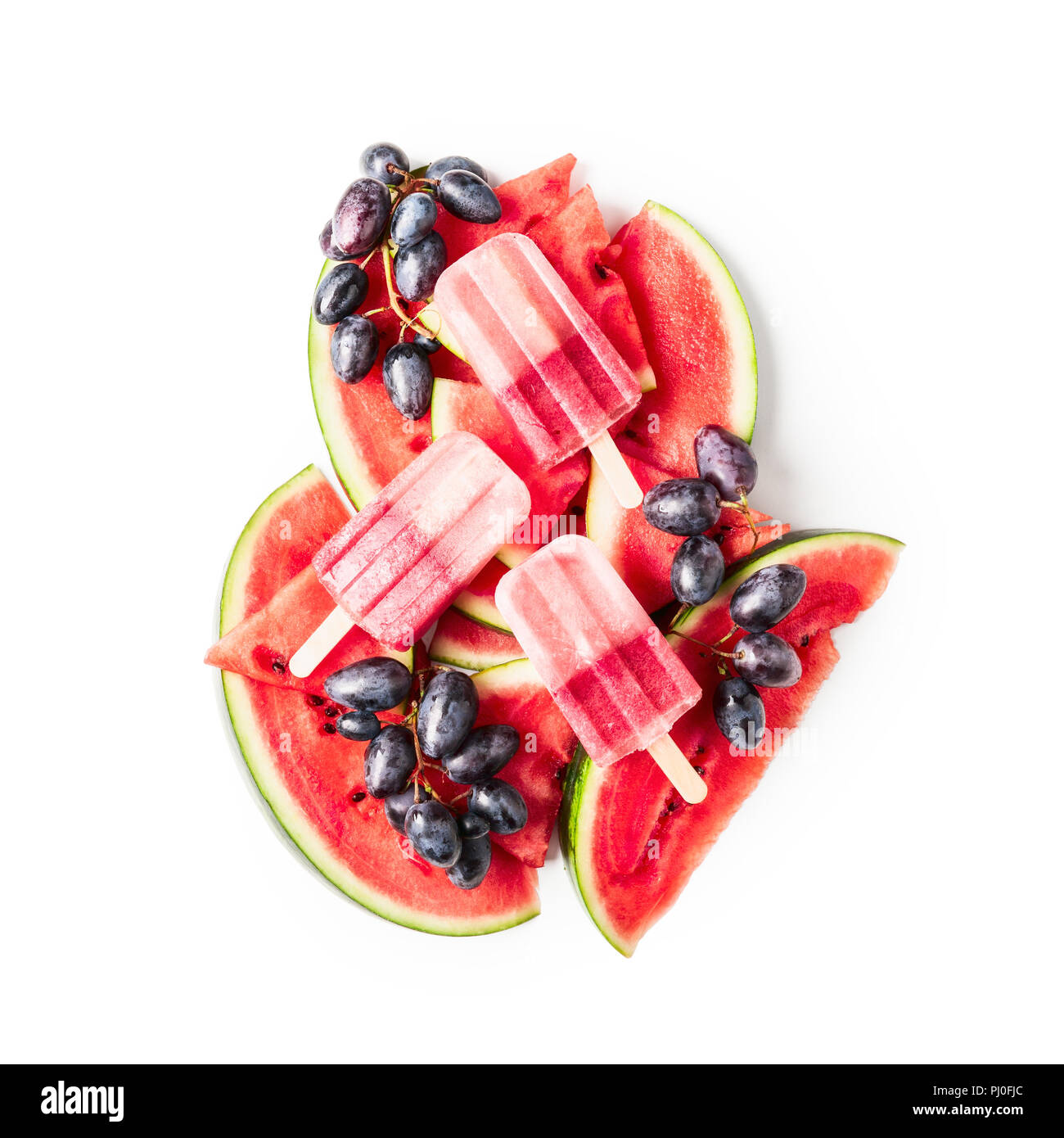 Popsicles, sliced watermelon and blue grape fruit berry isolated on white background clipping path included. Top view, flat lay. Design element Stock Photo