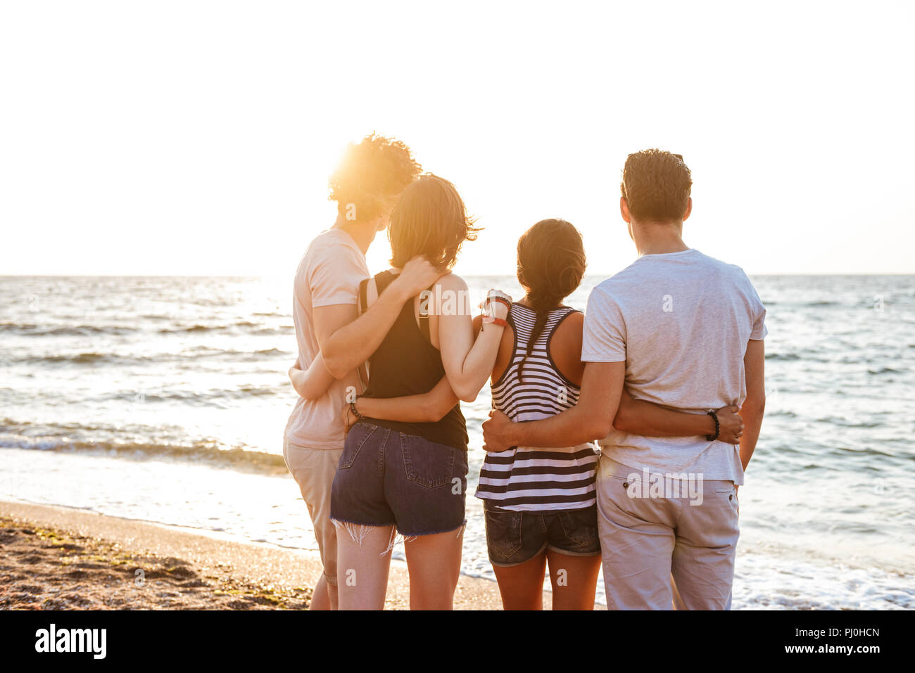 Back view picture of happy group of friends loving couples walking ...