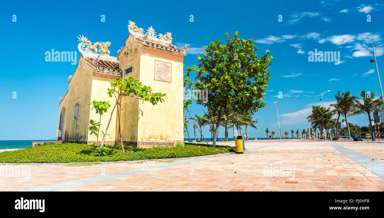 Da Nang, Vietnam - May 7, 2018: an old temple on the seafront sidewalk against blue sky on My Khe Beach. Stock Photo