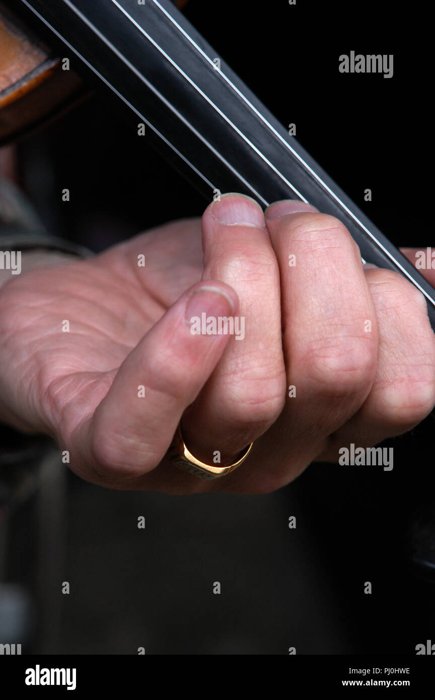 Closeup of mans fingers on Violin Strings Stock Photo Alamy