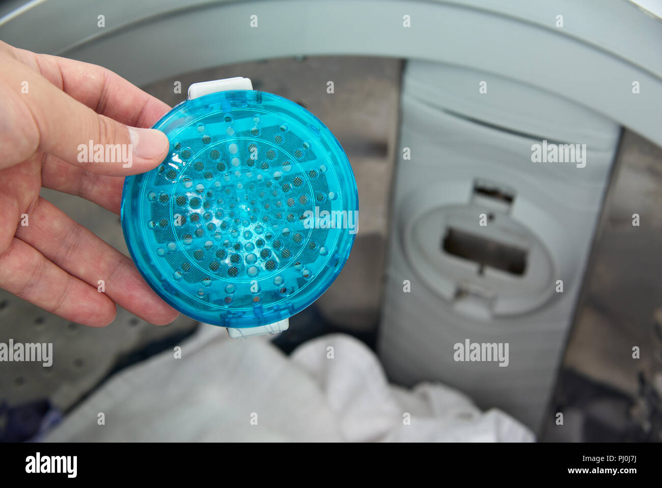 filter for filtering out dust from washing in a top load washer machine Stock Photo
