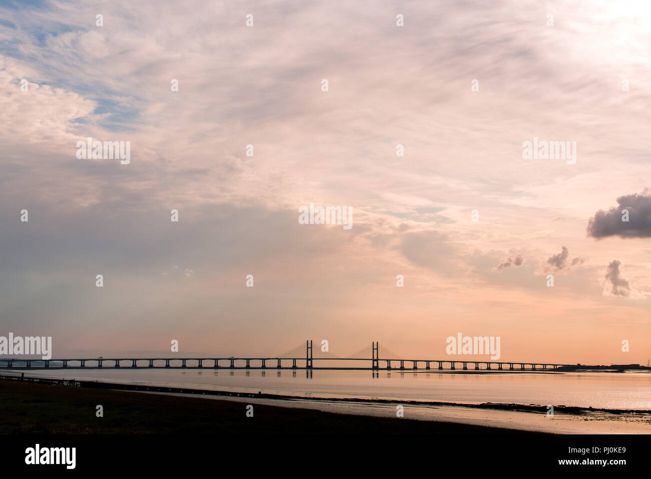 View of the Second Severn Crossing (Prince of Wales Bridge) from the English side (Old Passage, Aust) at low tide. Evening. Sunset. Summer. Stock Photo