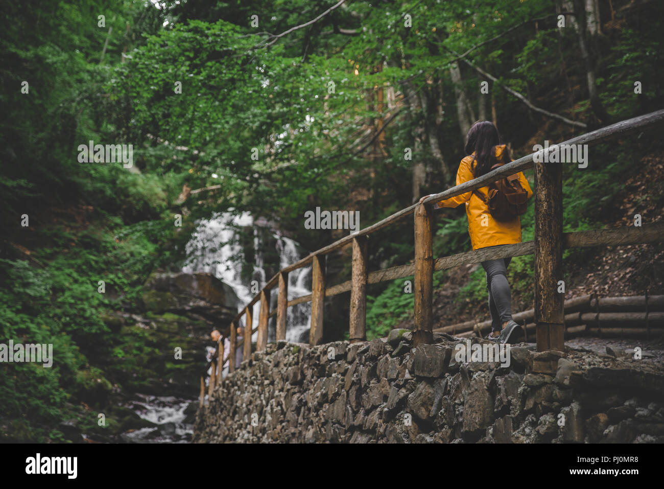 Woman in raincoat from behind hi-res stock photography and images - Alamy