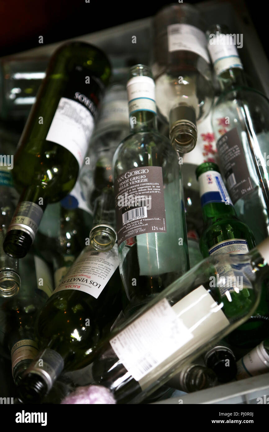 Selection of empty glass wine and beer bottles in a bin in London, UK. Stock Photo