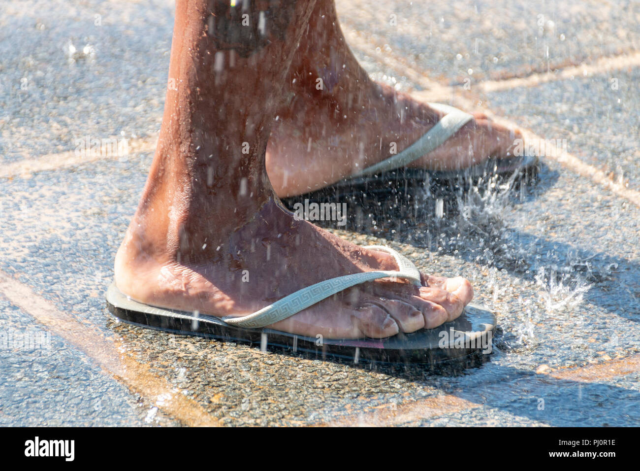 a close up view of a person washing there feet in an outdoor shower Stock Photo Alamy