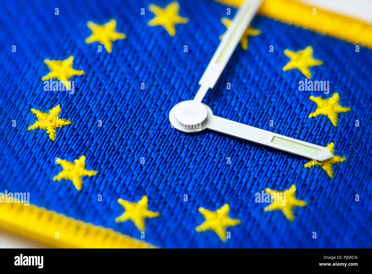 Watch hands on EU flag, end of changing clocks in the EU Stock Photo