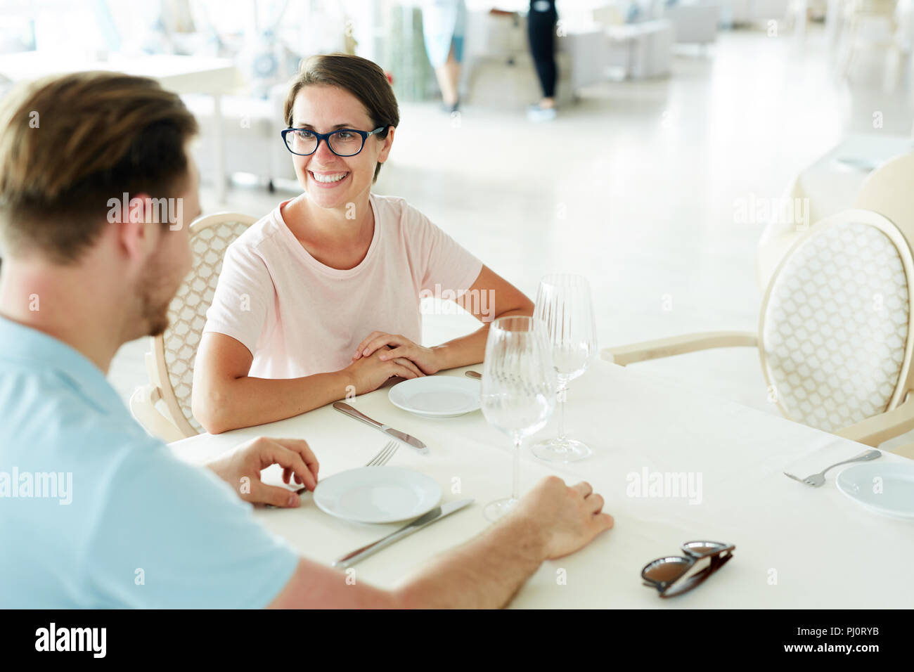 Couple Waiting for Food in Restaurant Stock Photo