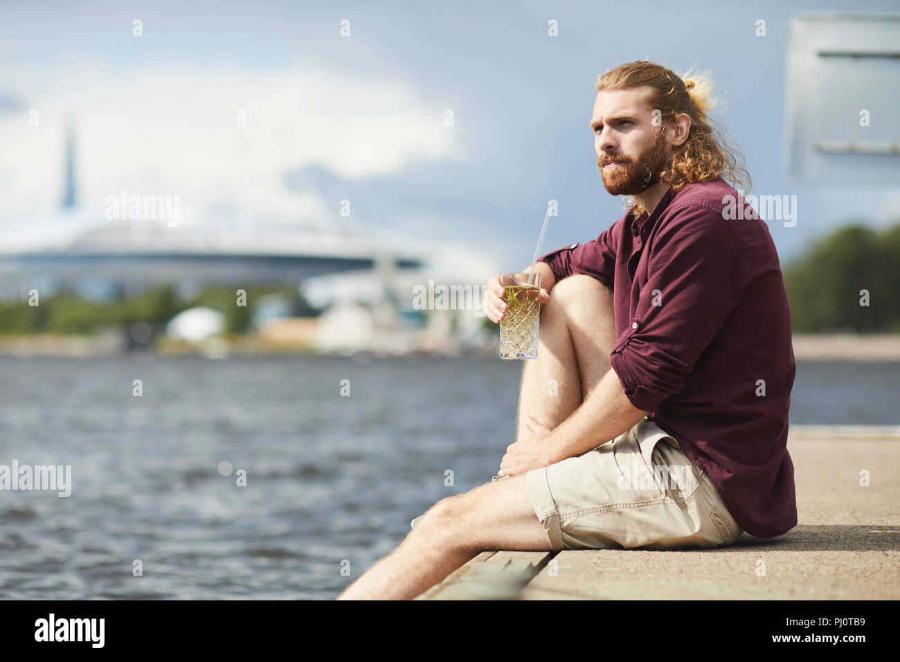 Guy by water Stock Photo