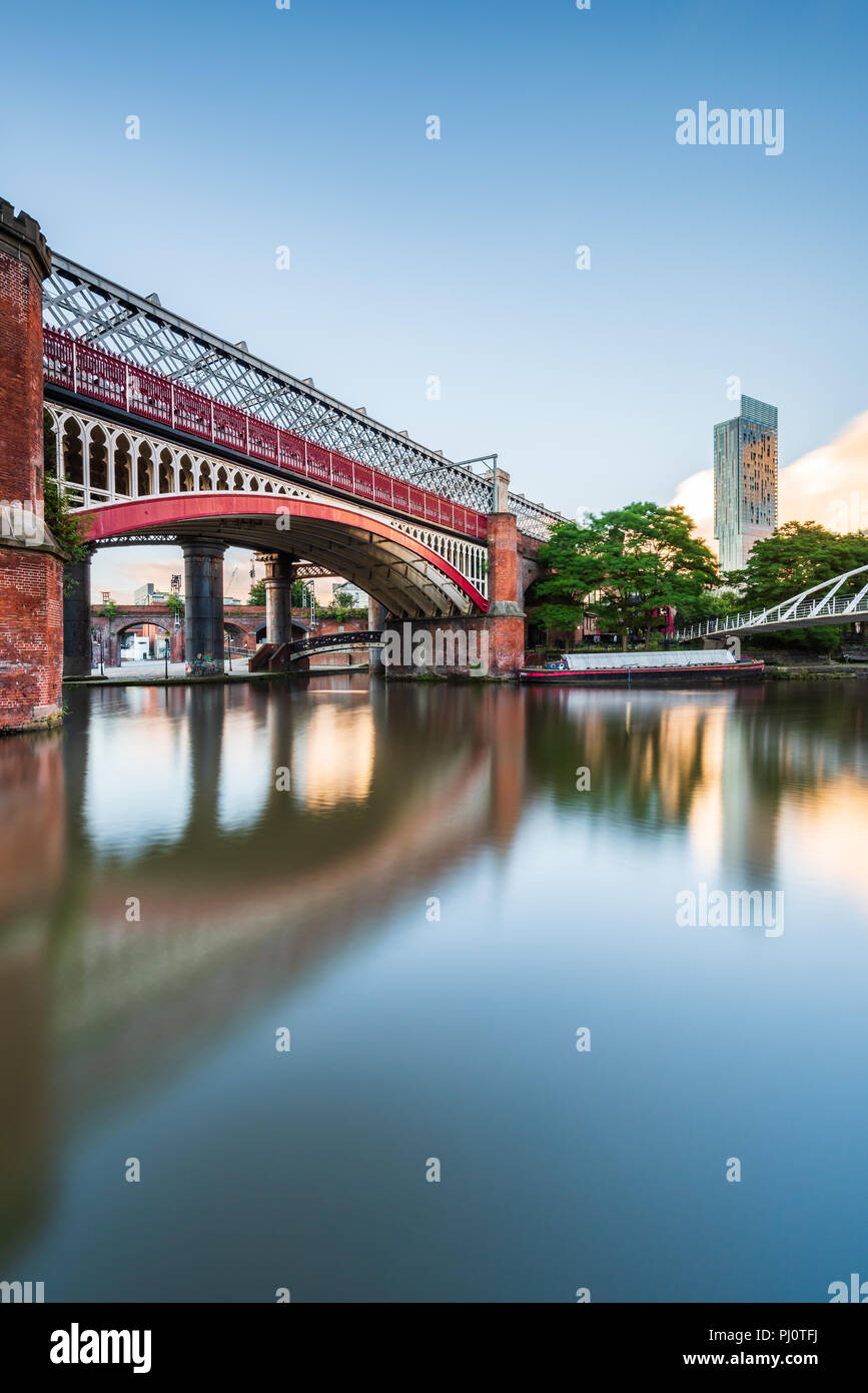Early morning view from the tow path alongside Bridgewater Canal in Castlefield, Manchester, showing the MSJAR and Merchant's bridges and the Hilton Stock Photo