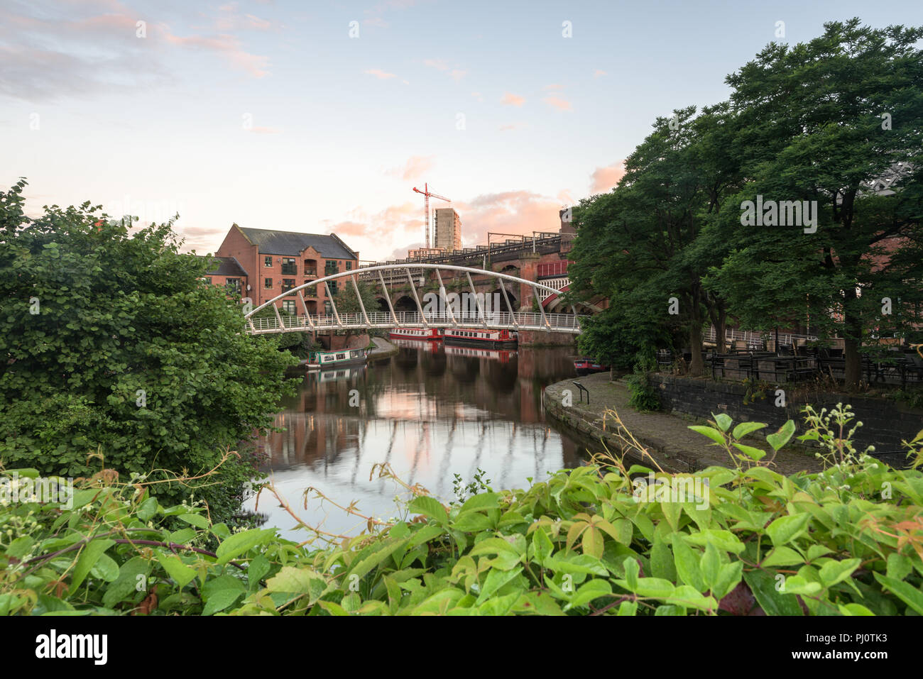 View towards the Whitby and Bird Merchant's footbridge in Castlefield, Manchester Stock Photo