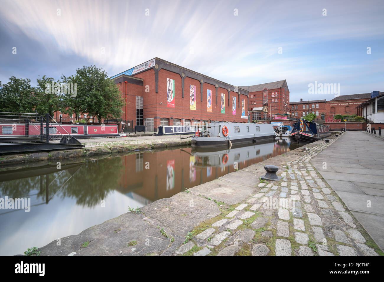 View from the towpath by the Bridgewater Canal in Castlefield, Manchester, looking towards narrowboats and MOSI Stock Photo