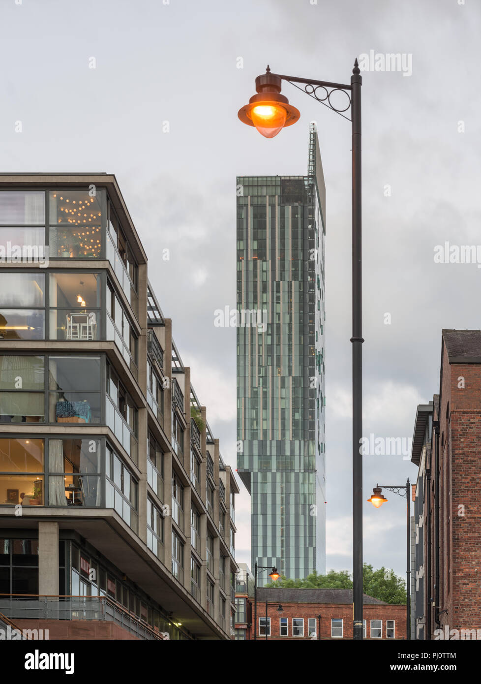 Portrait of the Hilton Hotel (Beetham Tower) from a low viewpoint showing an illuminated lamp post above the hotel Stock Photo