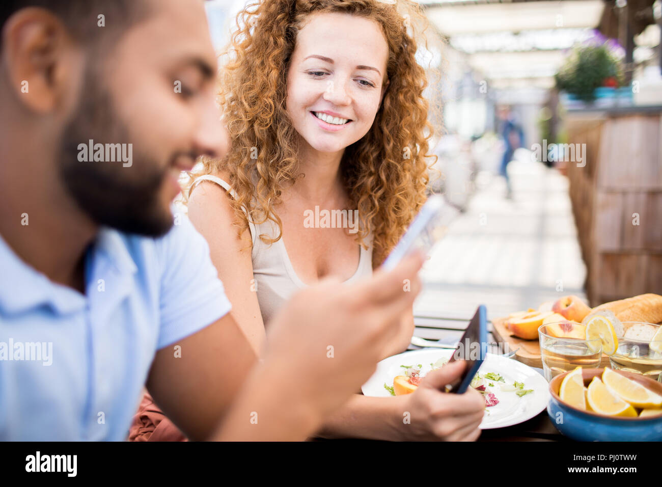 People Using Smartphones at Table Stock Photo