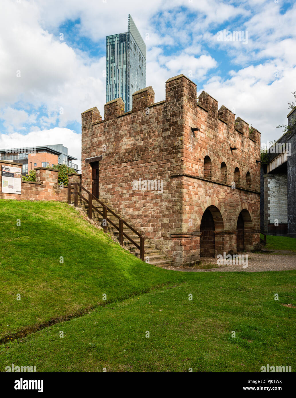 Roman Fort in Castlefield, Manchester, with the Hilton Hotel (Beetham Tower) in the background, showing contrast between old and new Stock Photo