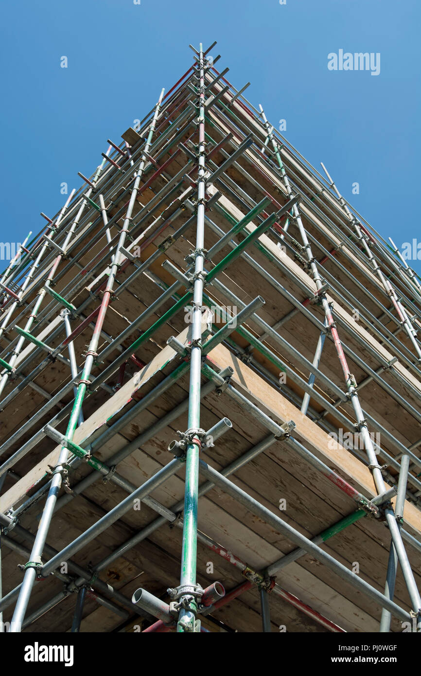 seen against a blue sky, scaffolding on corner building in belsize park