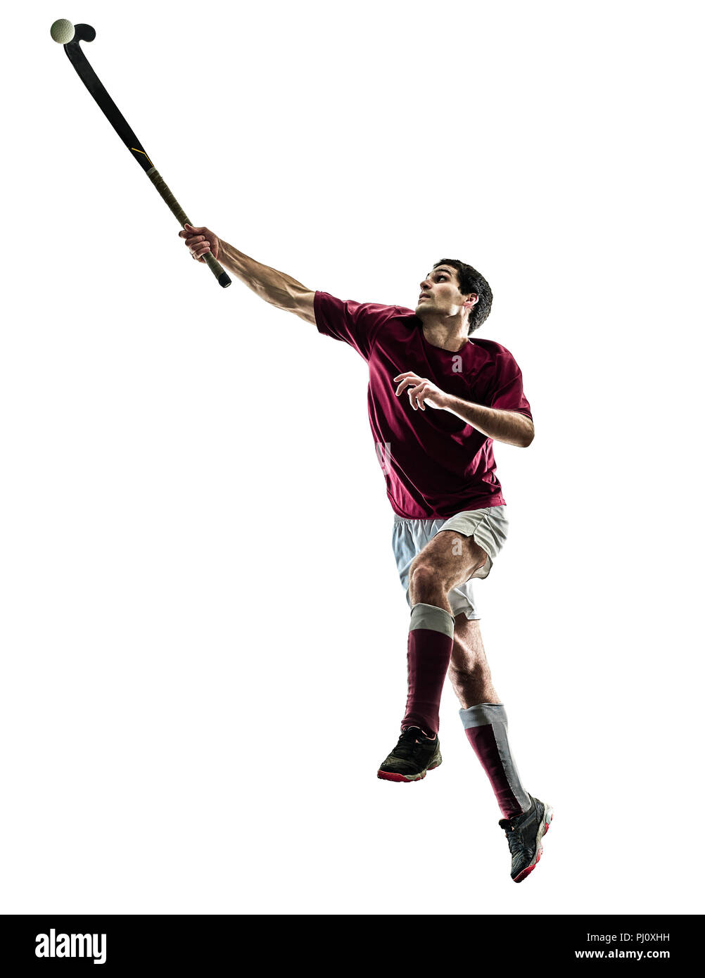 one caucasian field hockey player man isolated silhouette on white background Stock Photo
