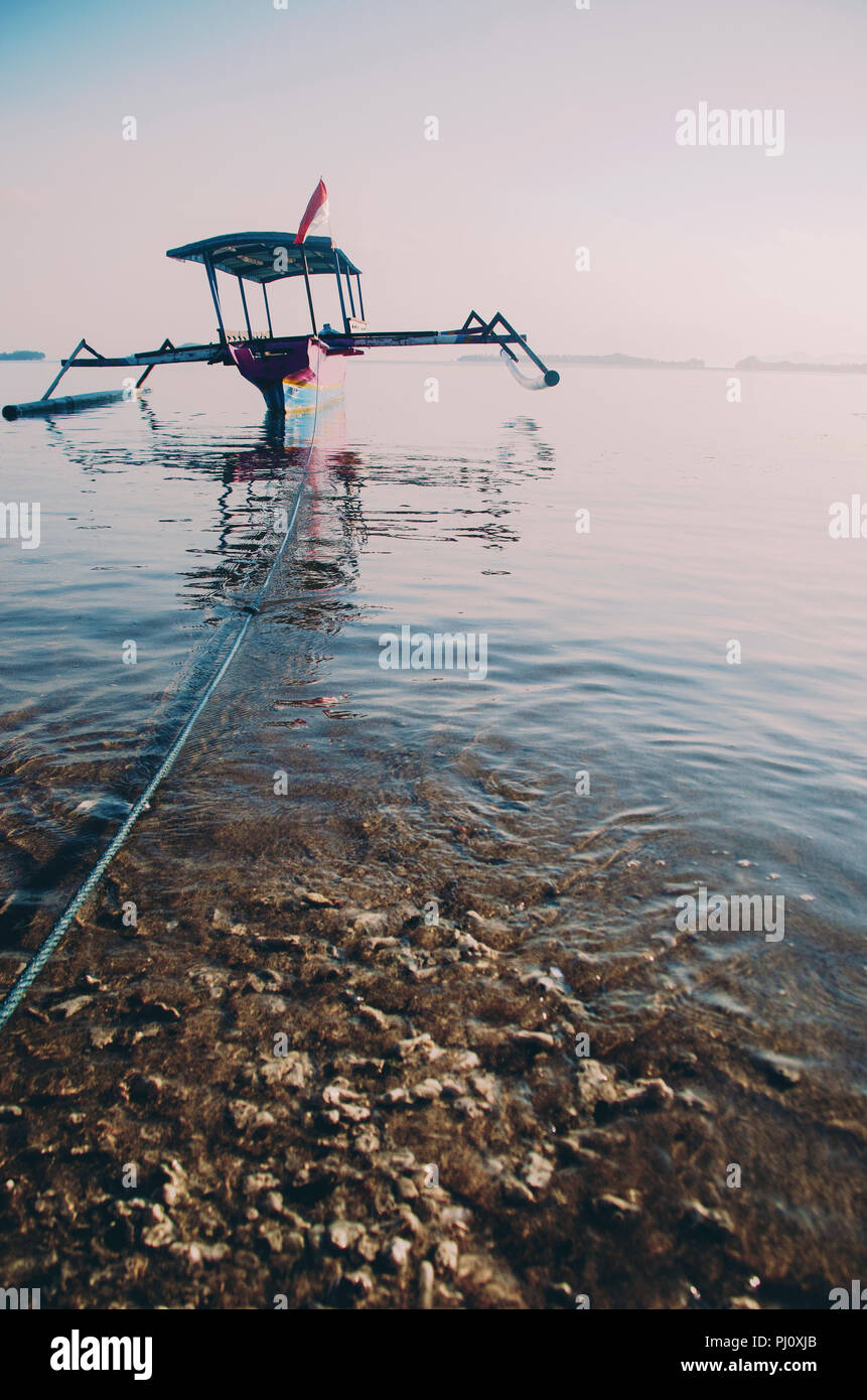 Traditional wooden fishing boat with motor in Indonesia Stock Photo - Alamy