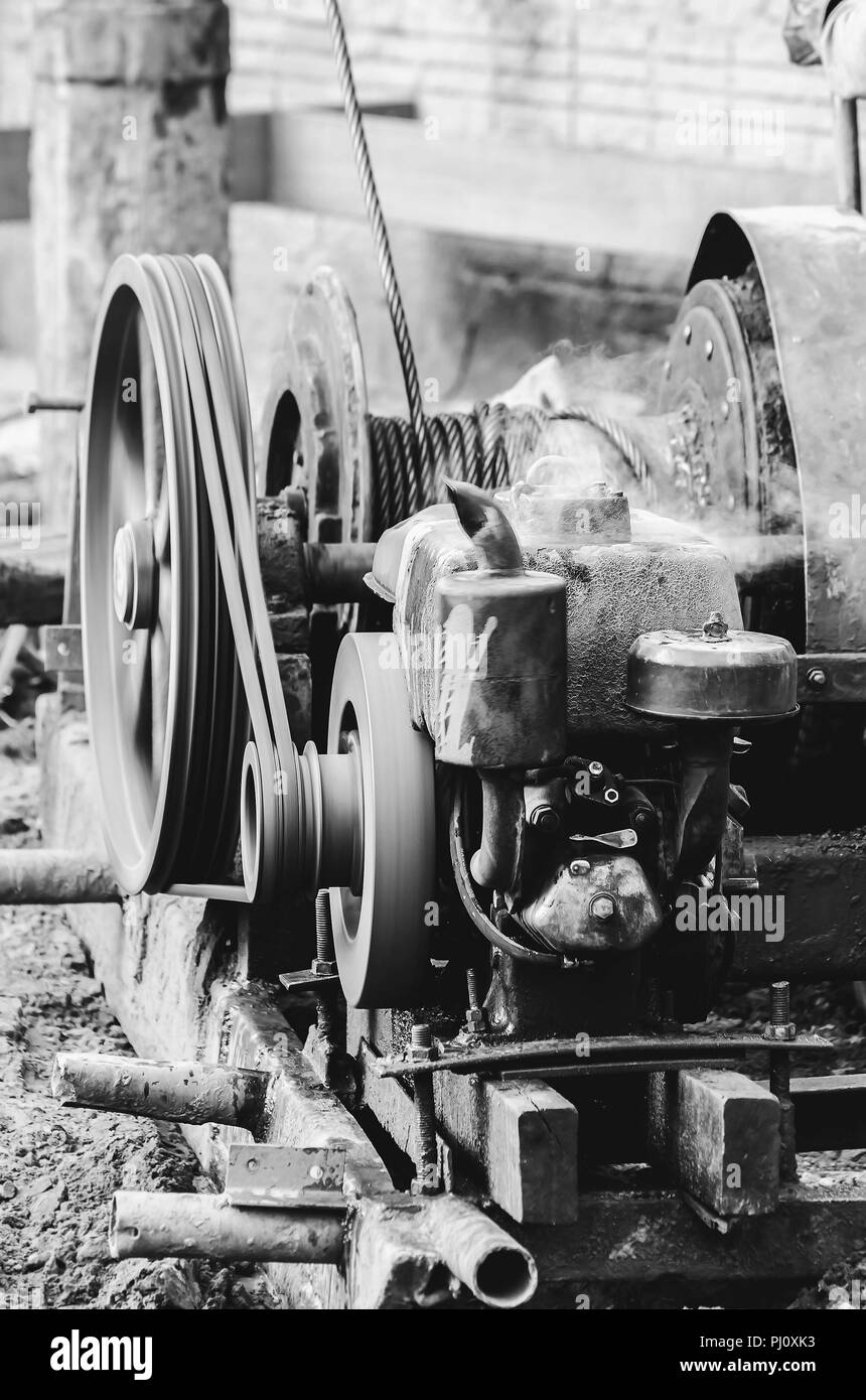 Motor of a pile driver (bate-estaca) used to dig the soil and make the foundation to support the building. Strauss piledriver driven by a motor. Black Stock Photo
