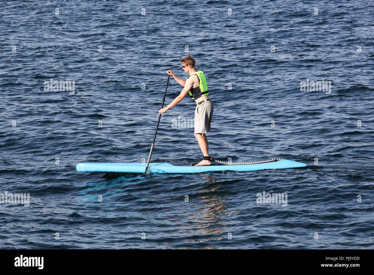 Aarhus, Denmark - August 7, 2018: Young man stand up paddle boards on the sea Stock Photo